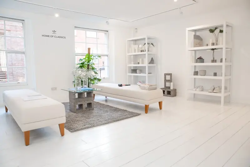A treatment bed beside a pale timber shelf.
